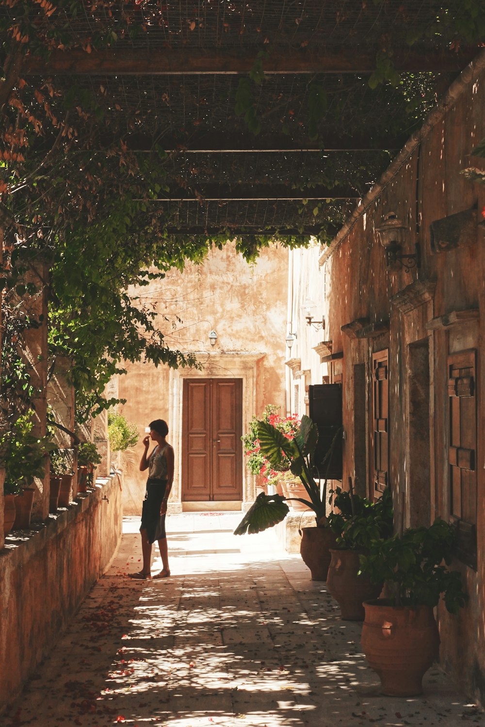 a person standing in an alley between two buildings