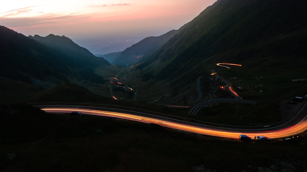 a long exposure shot of a road in the mountains
