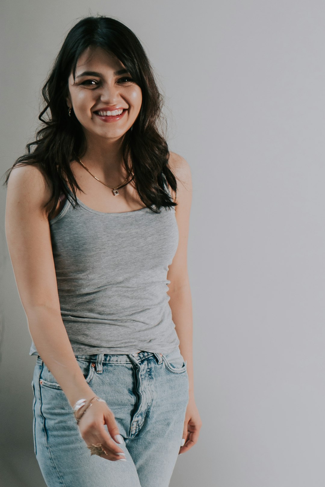 smiling woman wearing gray tank top