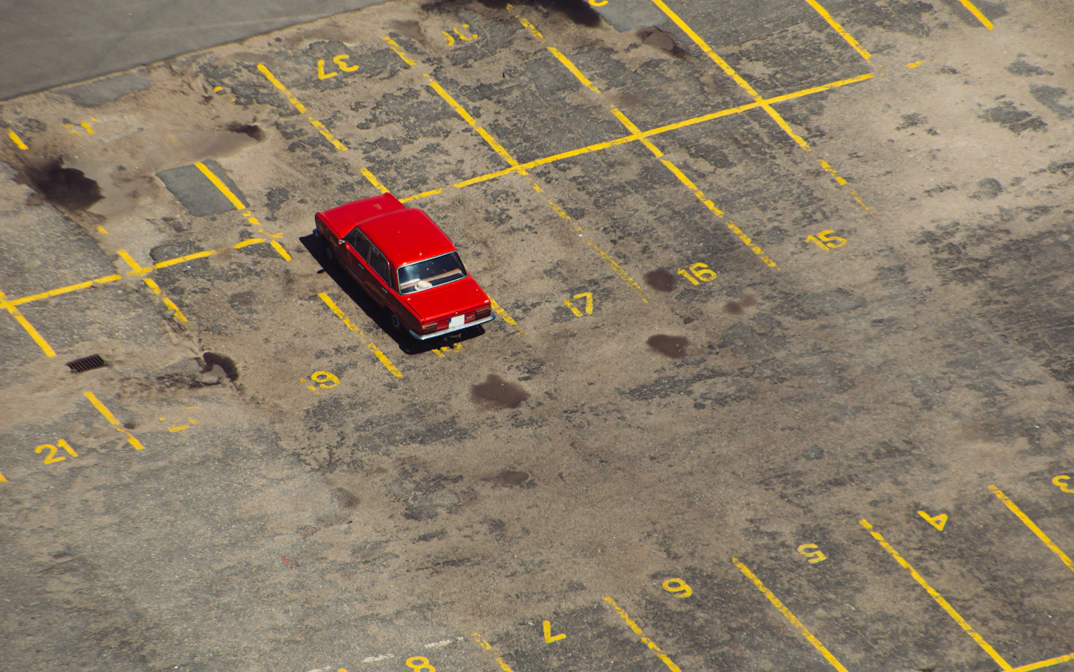 An empty small-business parking lot in late afternoon light during an off-season month