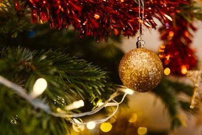 closeup photo of gold glittered christmas bauble noel teams background