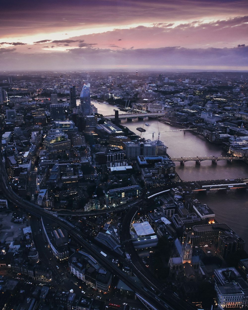 an aerial view of a city at dusk