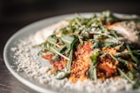 Close-up of a colorful plated dish with fresh ingredients.