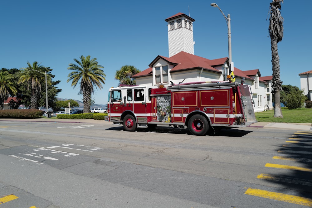 a red fire truck parked in front of a church