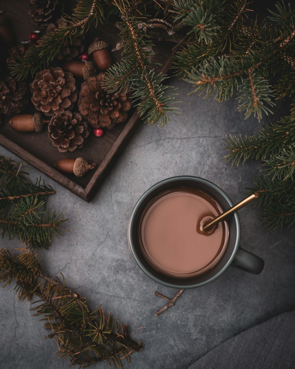 full mug beside pinecones