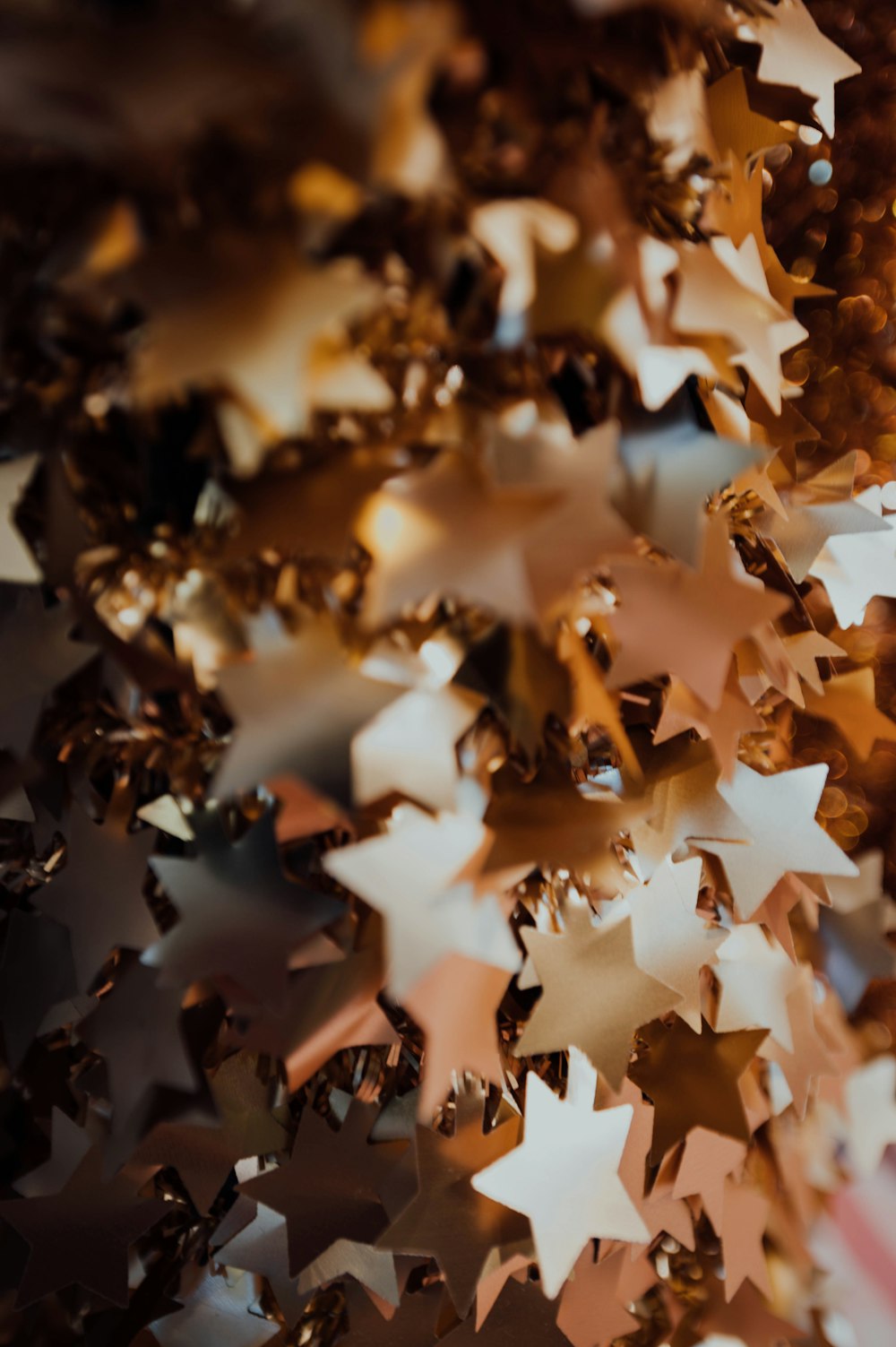 a bunch of gold stars hanging from a ceiling