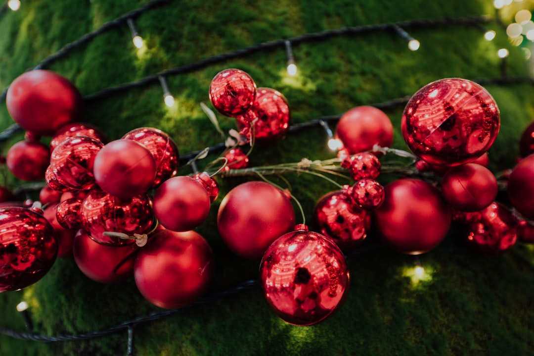 red baubles and mini string lights on green surface