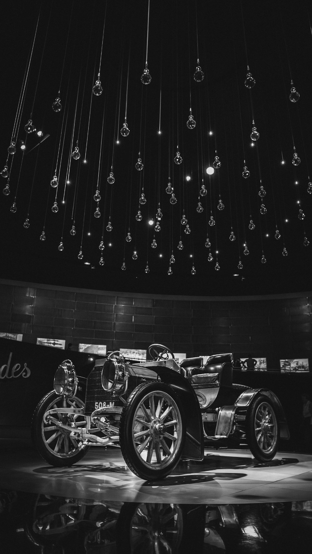 grayscale photography of vintage vehicle in museum