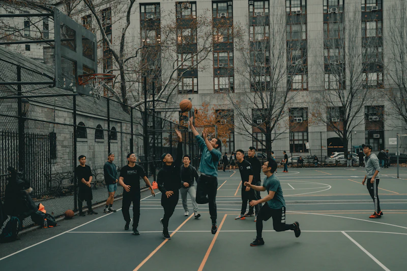 Basketball players competing for a shot at the hoop