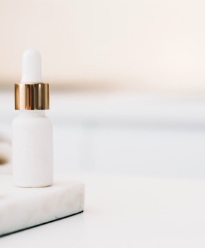 white drop bottle on white surface