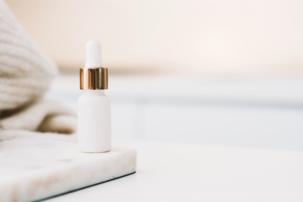 white drop bottle on white surface