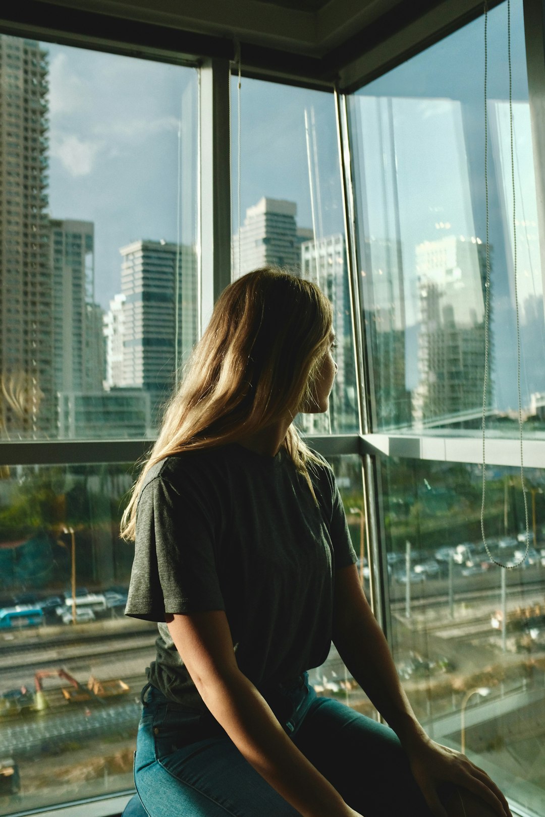 woman leaning on glass window