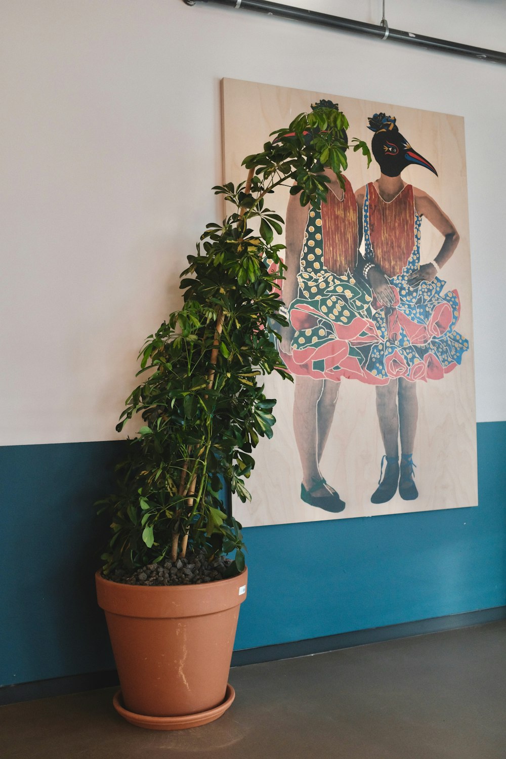 green indoor plants beside painting