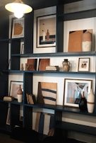 A sleek shelving unit displaying curated home accessories and modern art pieces.