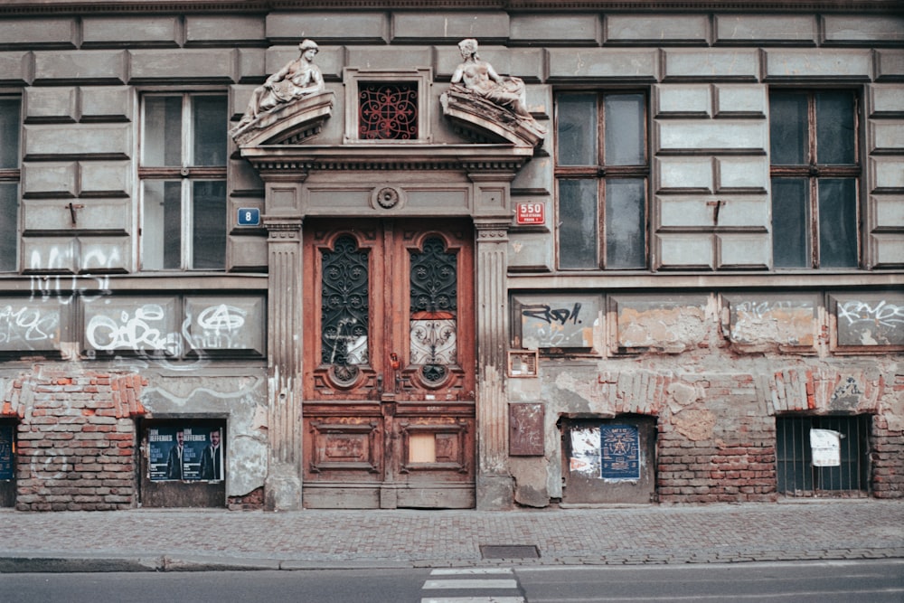 closed brown wooden half lite door of concrete building