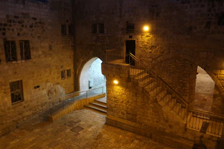 Cozy courtyard in Vieux Lyon with warm evening light and historic stone buildings.