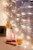 A cozy, softly lit corner with a warm blanket and a steaming cup of tea by a window.