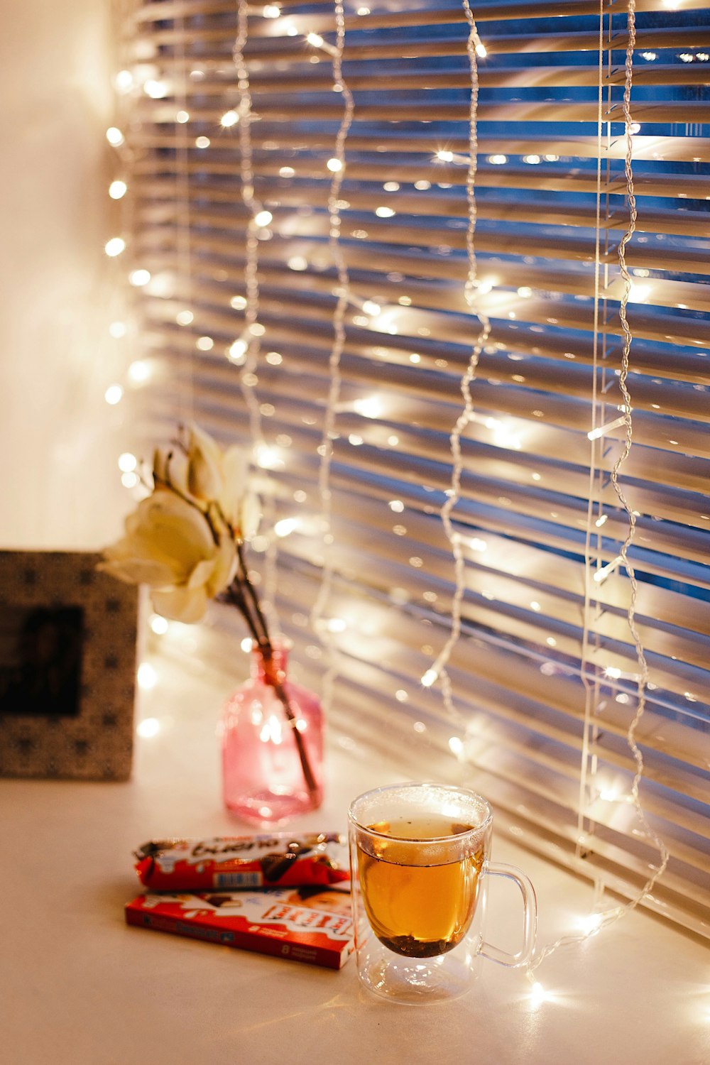 rose, mug, and string lights