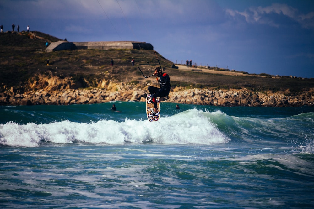 person wakeboarding under blue sky