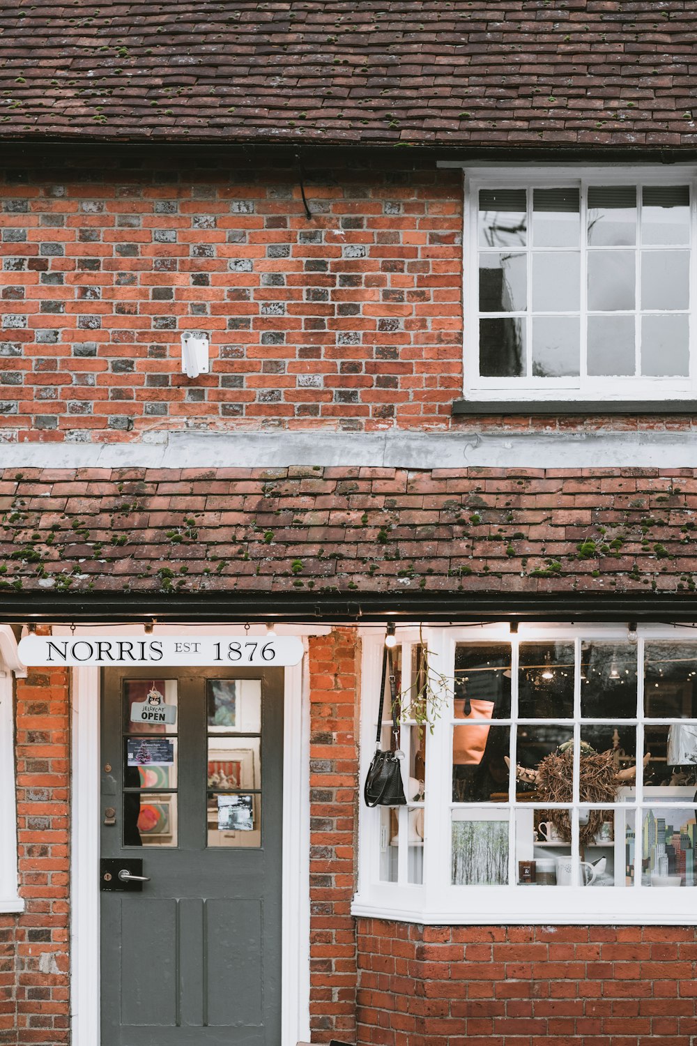 building with closed door and Norris EST 1876 sign