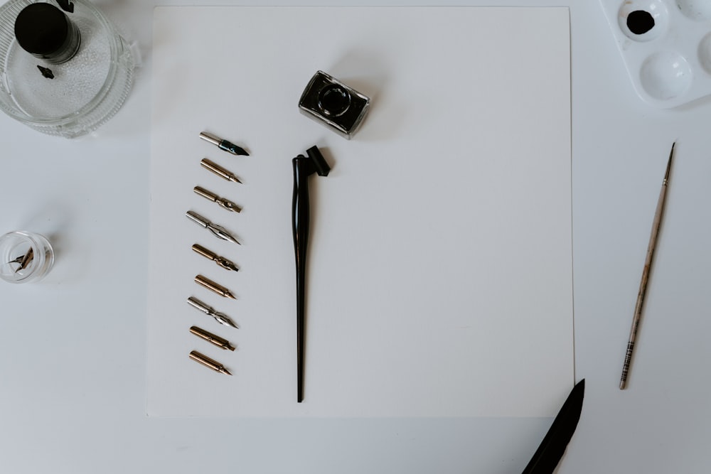 a white table topped with lots of art supplies