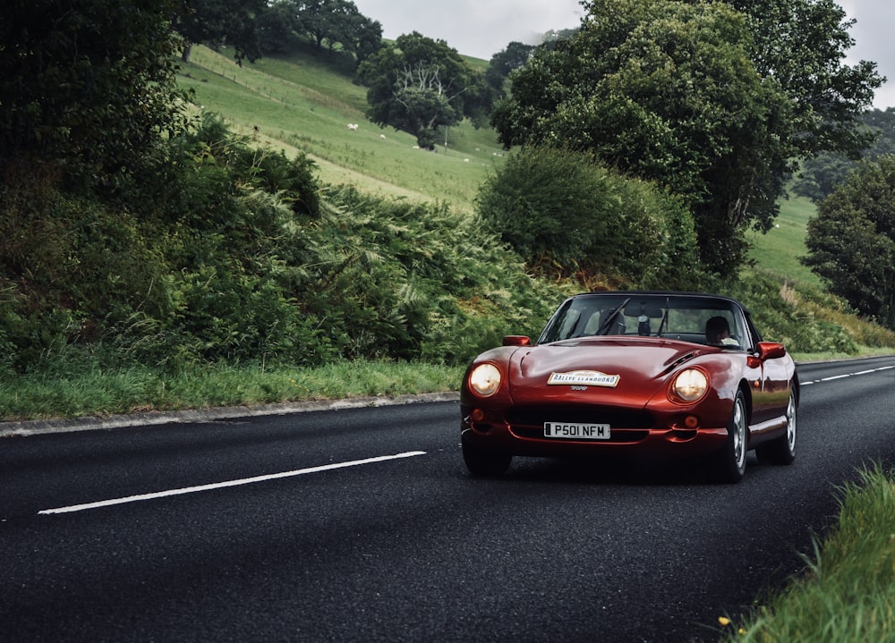 red coupe on road during day