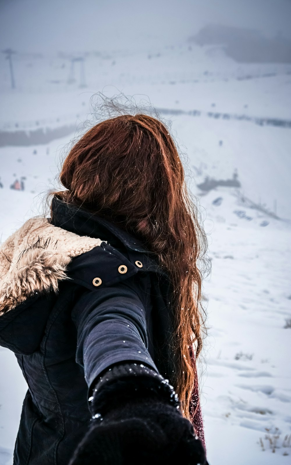 woman wearing parka on snowfield