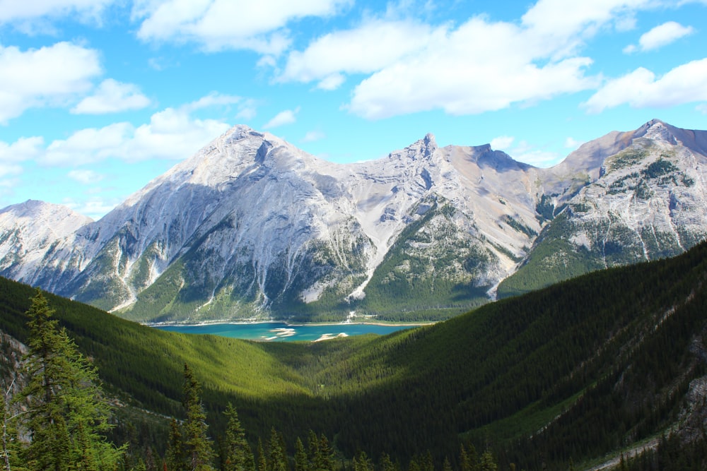 body of water and mountains under blue sky