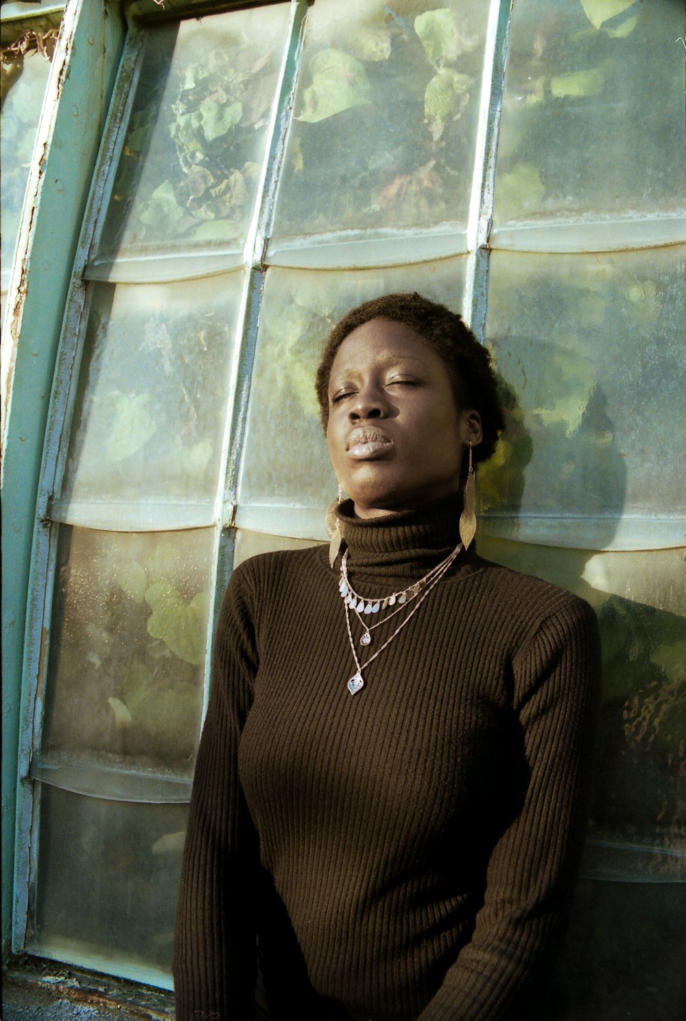 woman in black turtleneck sweater beside window