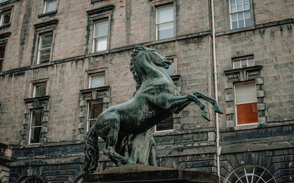 a statue of a horse in front of a building