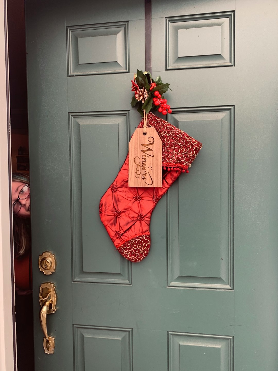 red Christmas stockings on wooden door