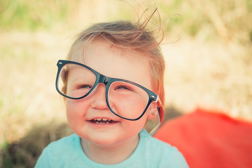 baby wearing black framed eyeglasses