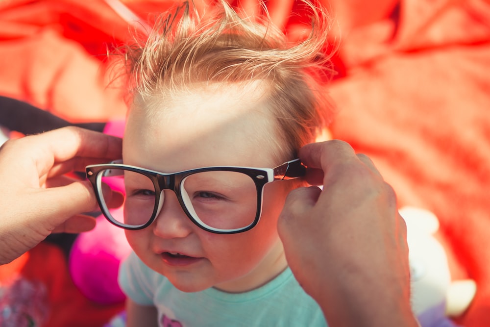 toddler wearing black framed eyeglasses
