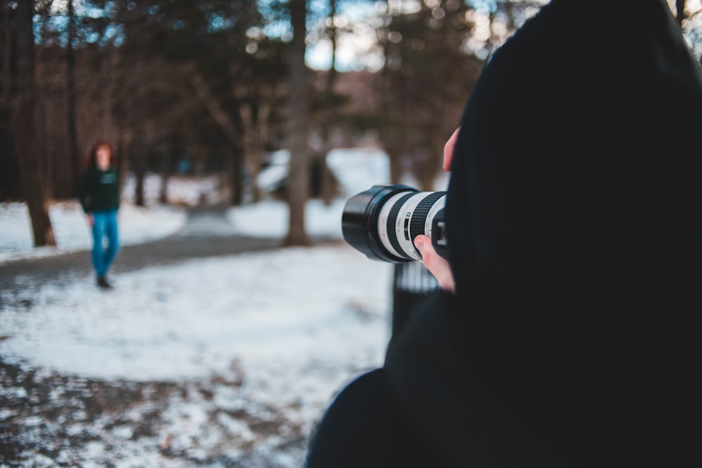 person taking woman's photo