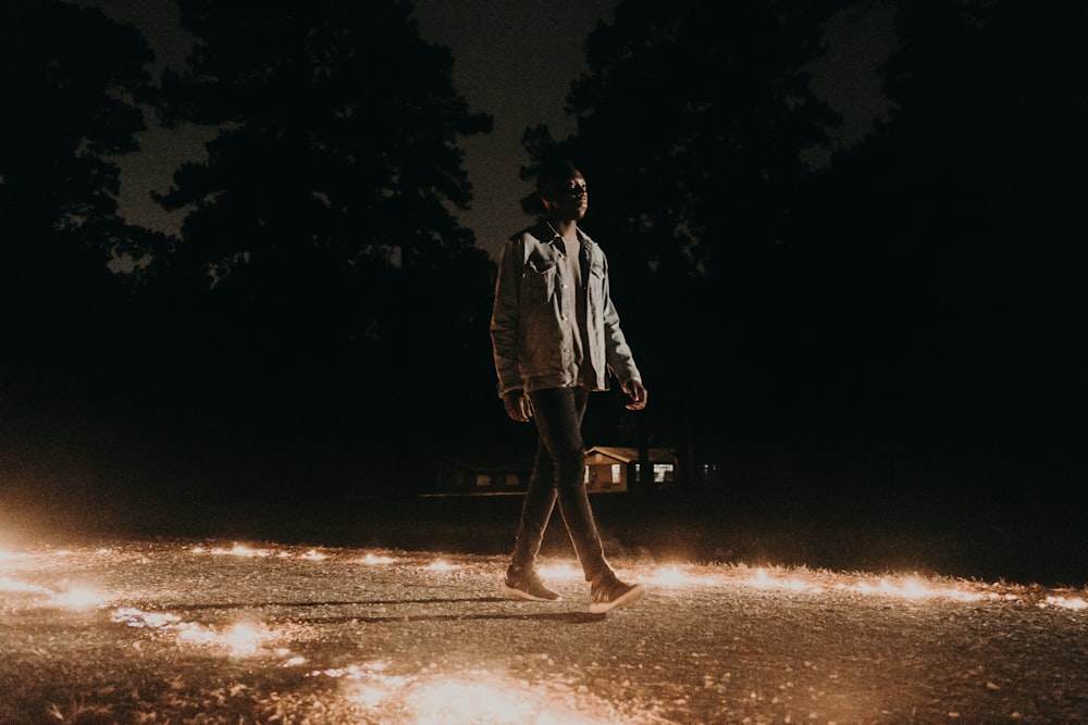man walking near trees during night