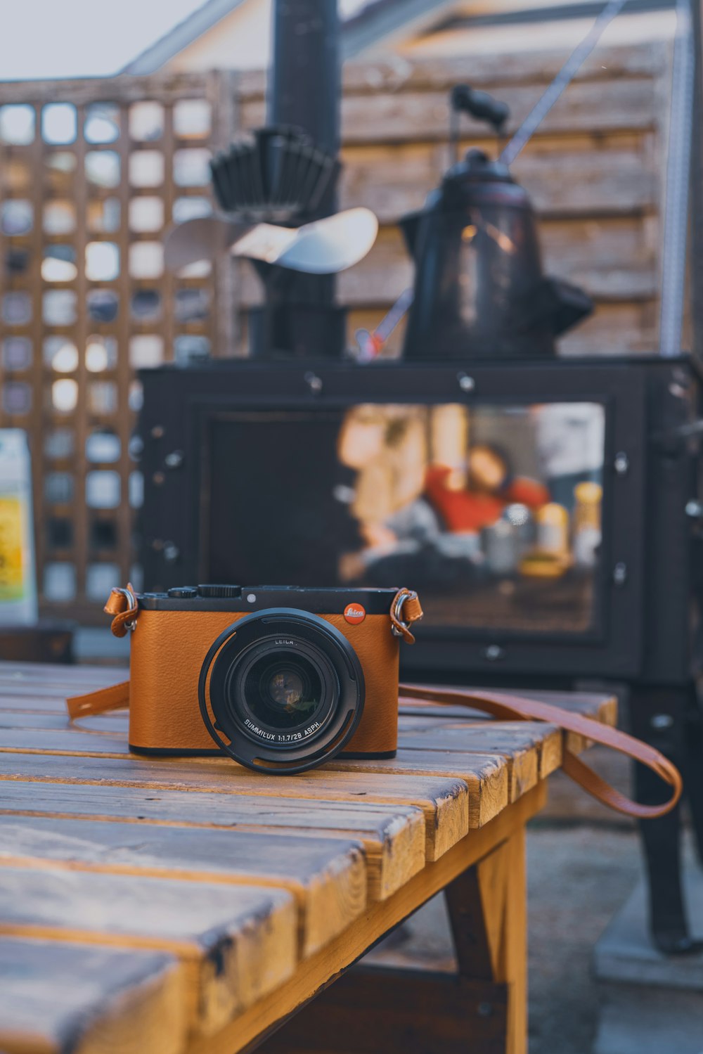 black and brown DSLR camera on table