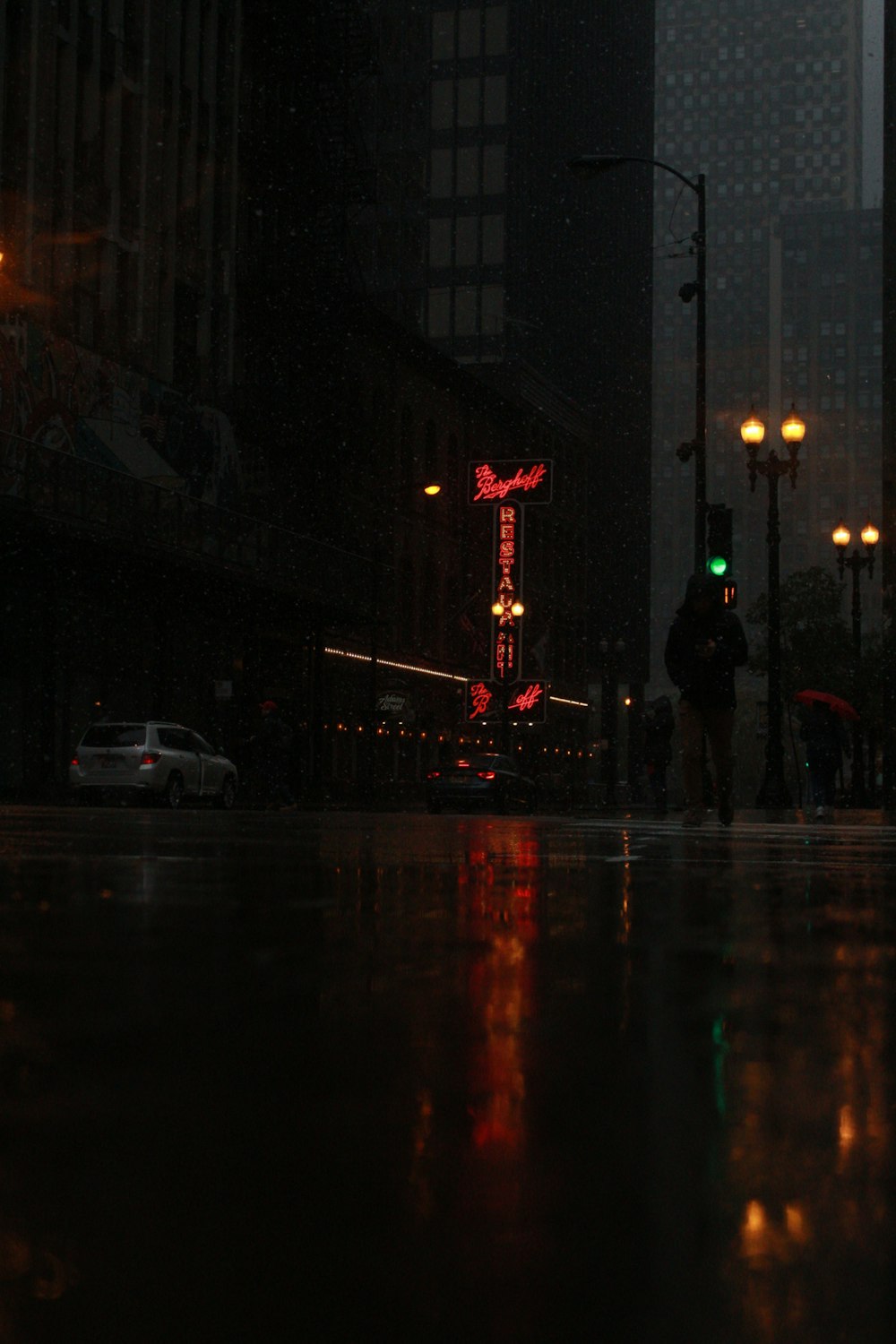 a person walking down a street at night