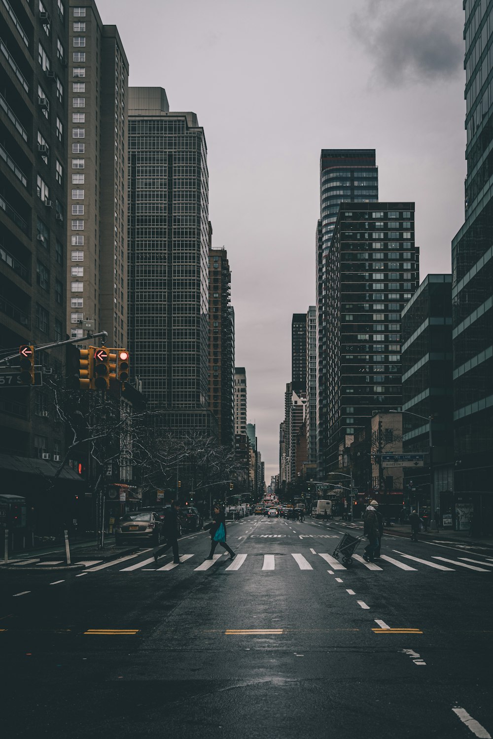 people crossing street near buildings