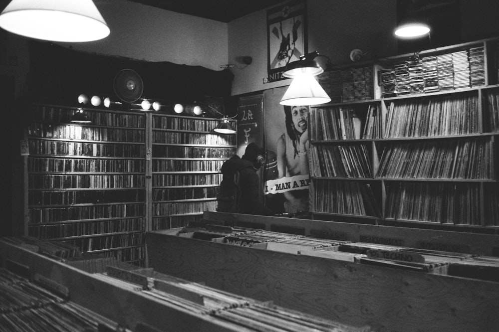 grayscale photo of book lot on bookshelf