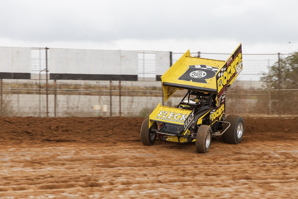 yellow Sprint car racing at the race track