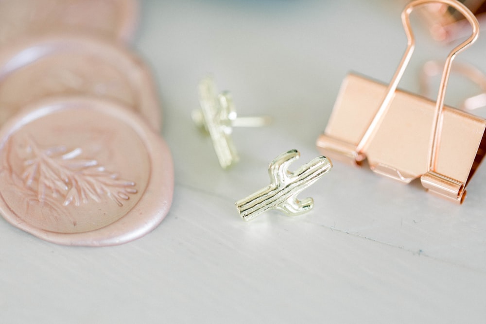 a pair of earrings sitting on top of a table