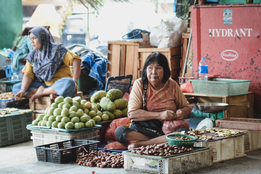 woman sitting near fruits