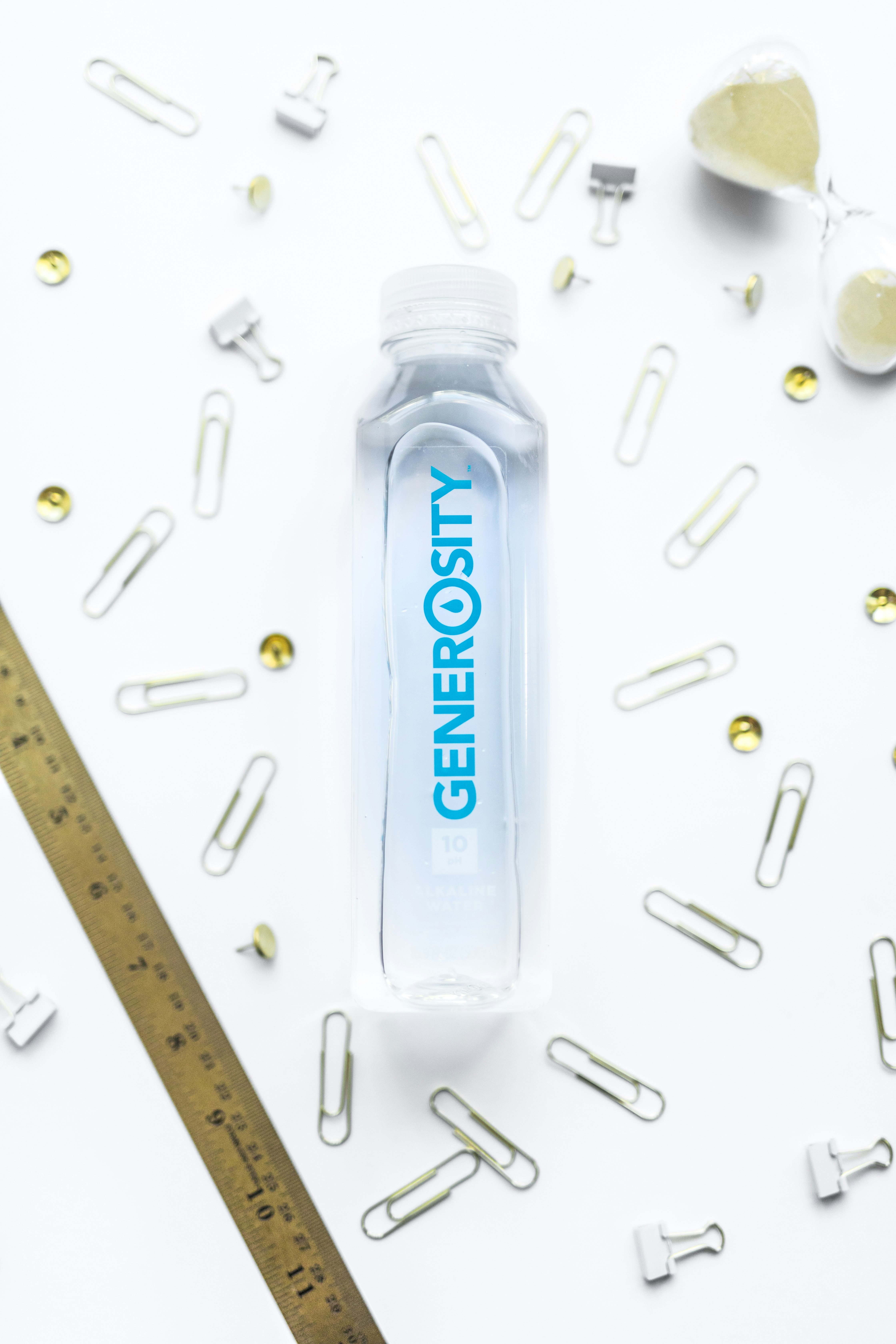 clear Generosity plastic bottle on white surface