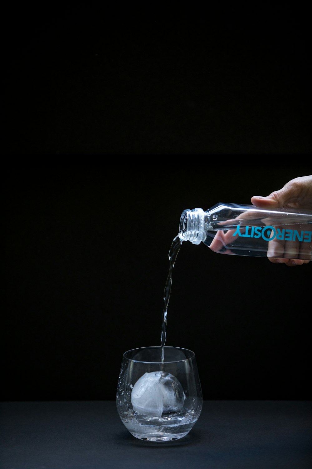 Generosity bottle pouring into glass of ice