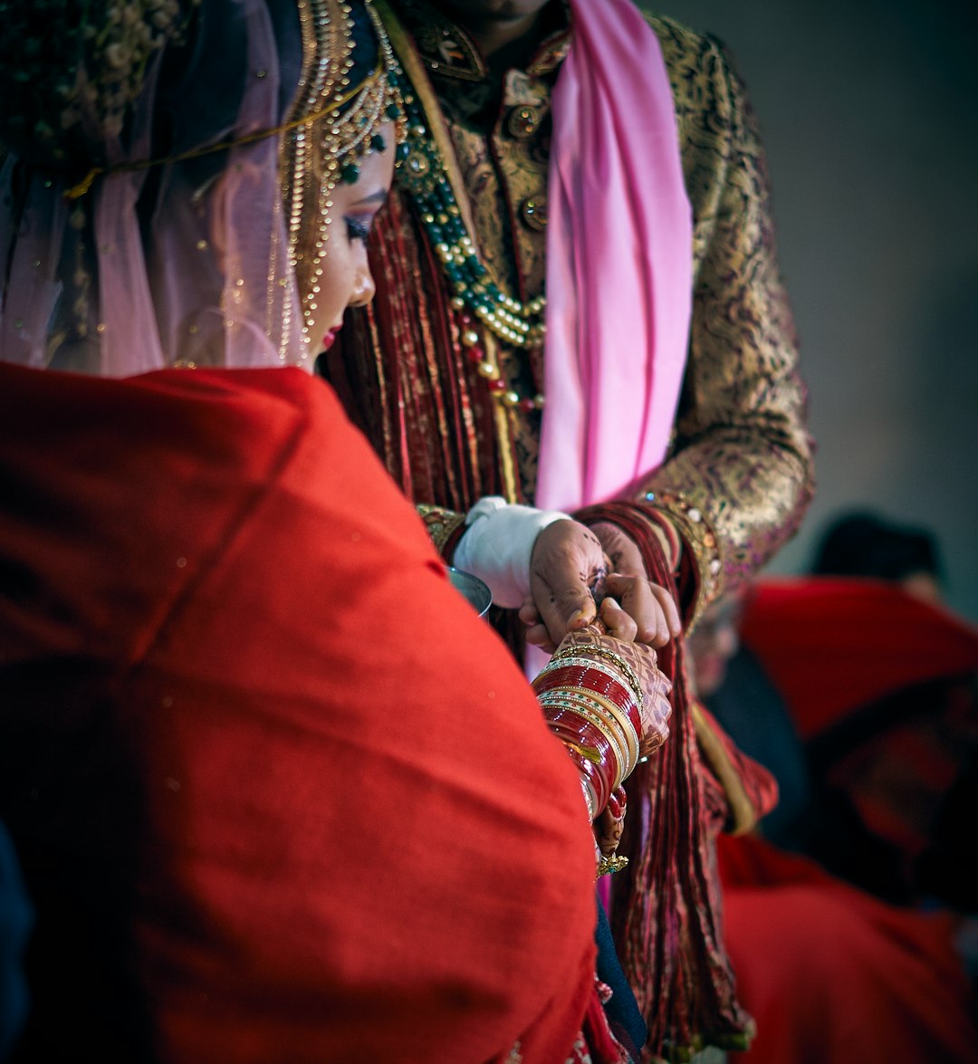 selective focus photography of man holding hand of woman