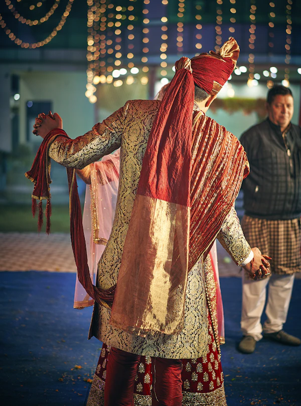 Groom dressed in traditional red sherwani