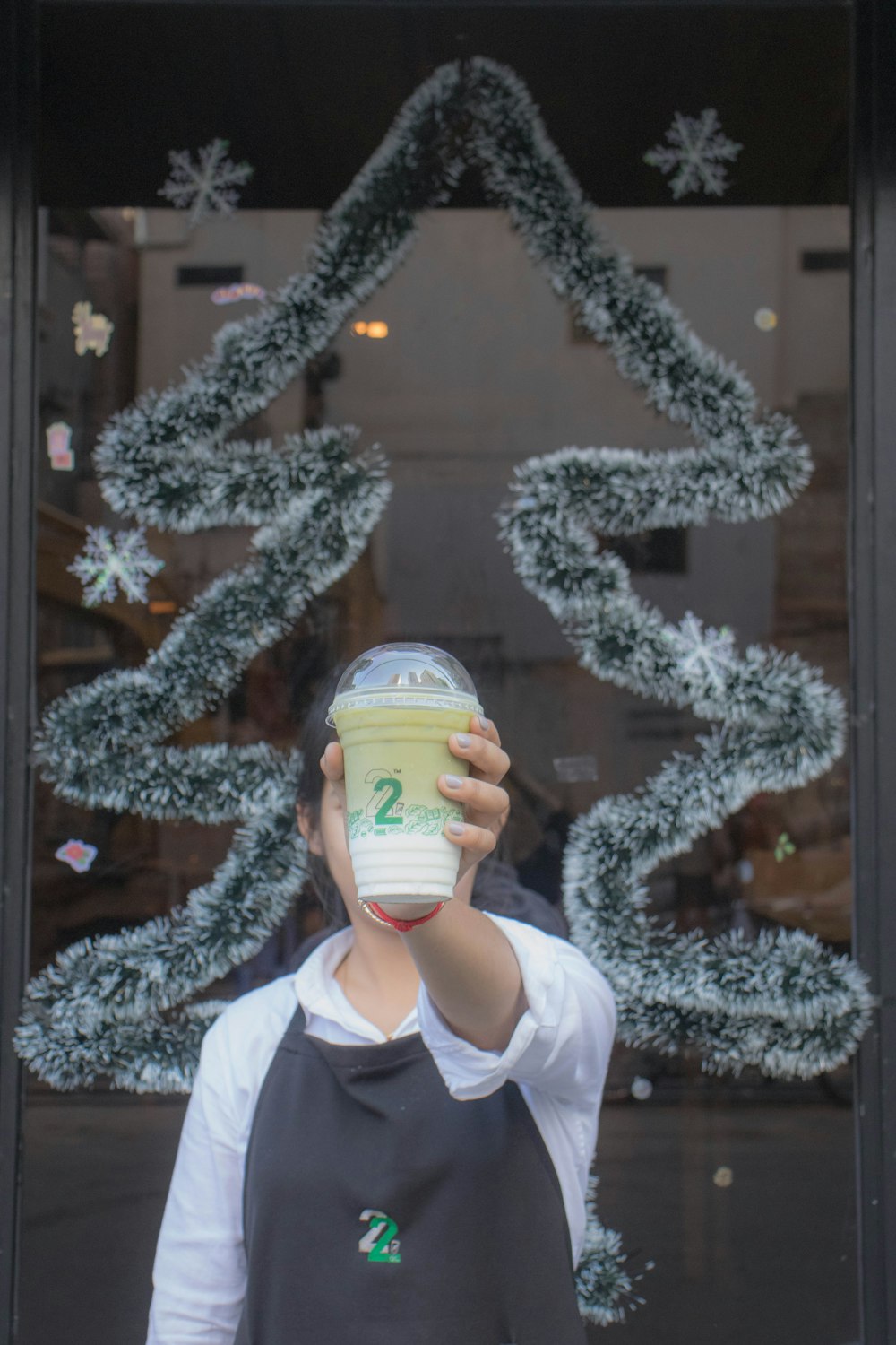 woman holding a cold cup