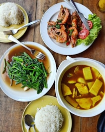 cooked food and rice placed on table