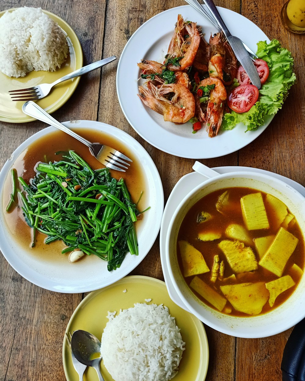 cooked food and rice placed on table