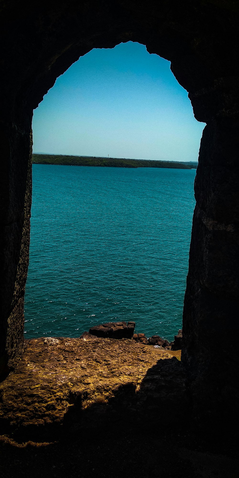 brown rock formations beside body of water